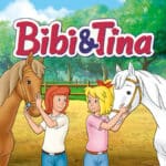 Bibi und Tina mit Sabrina und Amadeus unter Bibi und Tina Logo. Im Hintergrund ist der Pferdestall.